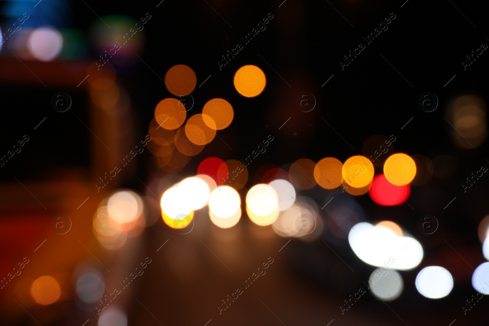 Photo of Blurred view of cityscape with bokeh effect. Night life