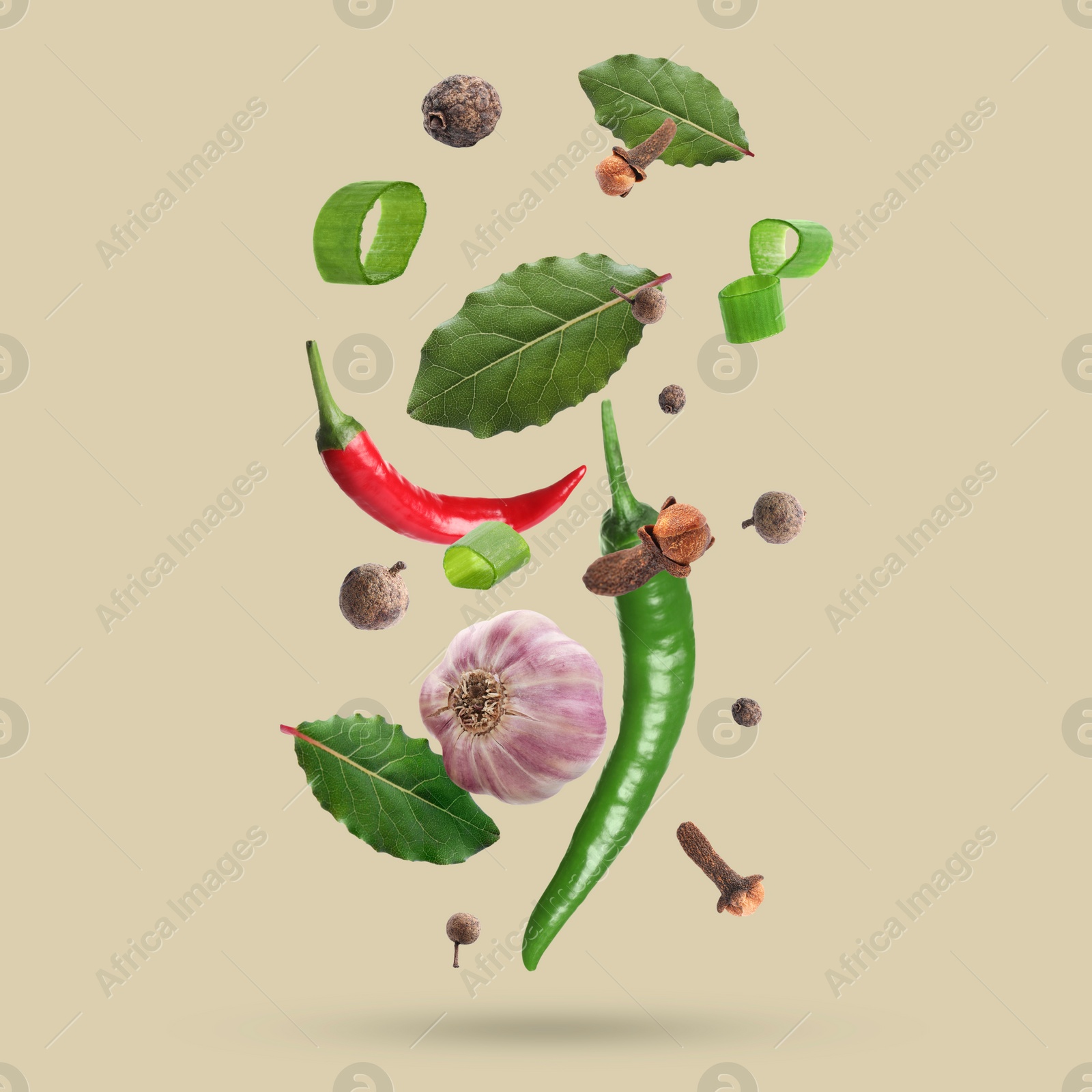 Image of Different spices falling on dark beige background