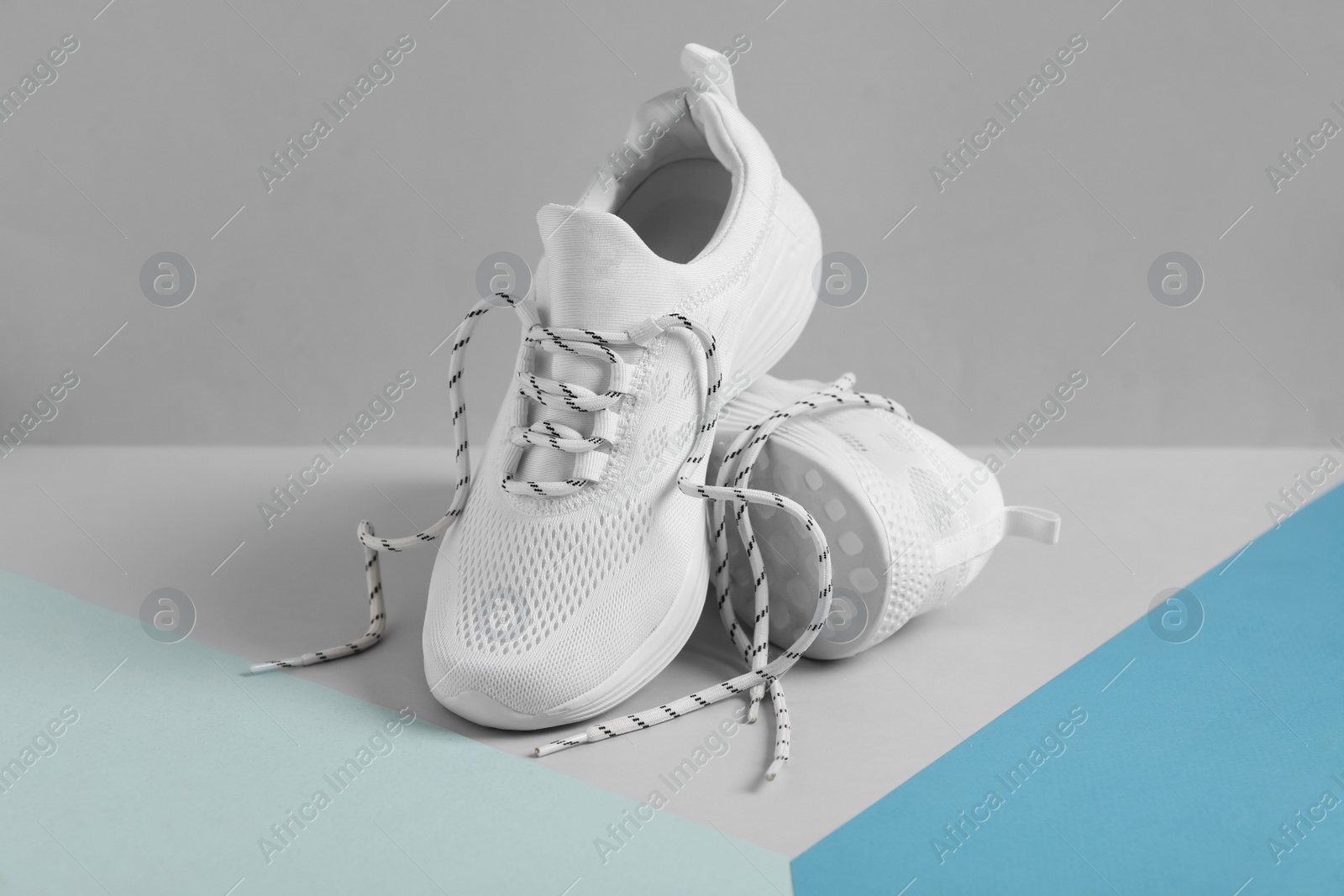 Photo of Pair of stylish shoes with laces on color background