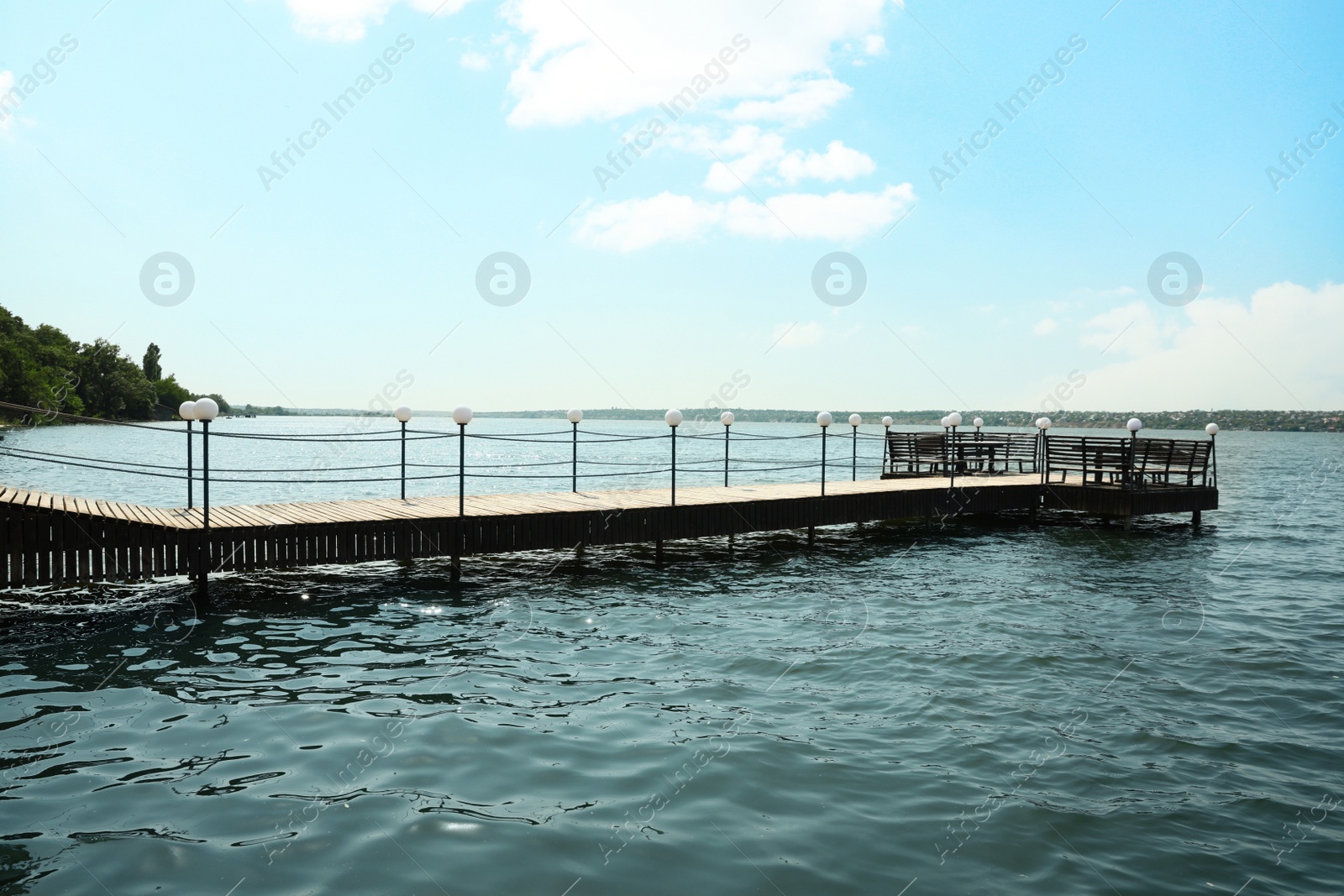 Photo of Beautiful river scene with wooden pier on sunny day