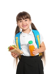 Schoolgirl with healthy food and backpack on white background