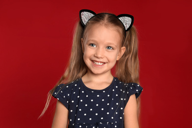 Photo of Portrait of cute little girl on red background