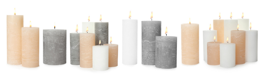 Image of Set of burning color candles on white background. Banner design