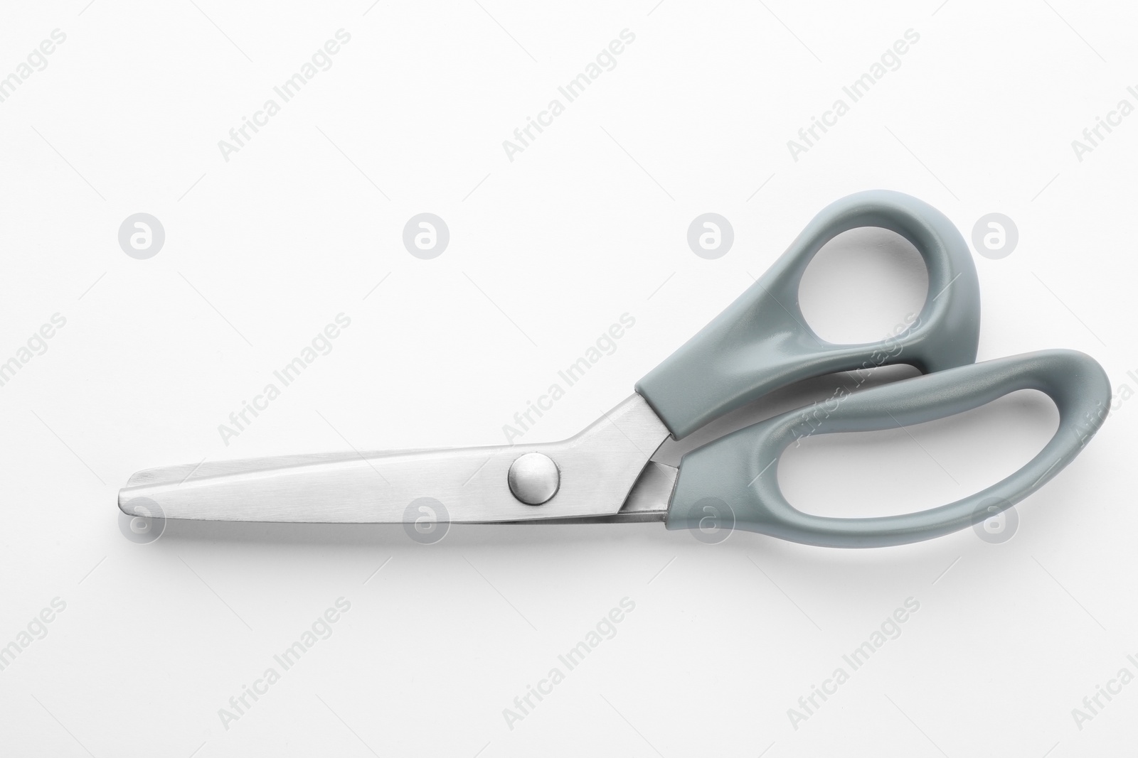 Photo of New pair of sewing scissors on white background