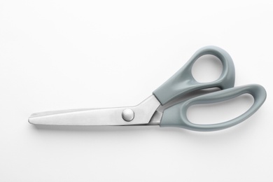 Photo of New pair of sewing scissors on white background