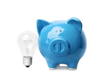 Photo of Piggy bank with light bulb on white background