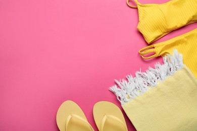Flat lay composition with different beach objects on pink background, space for text
