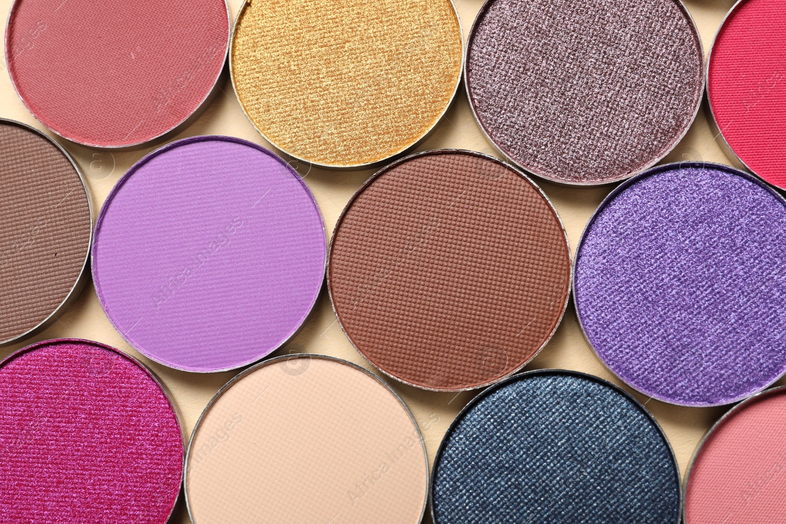 Photo of Different beautiful eye shadows on beige background, flat lay