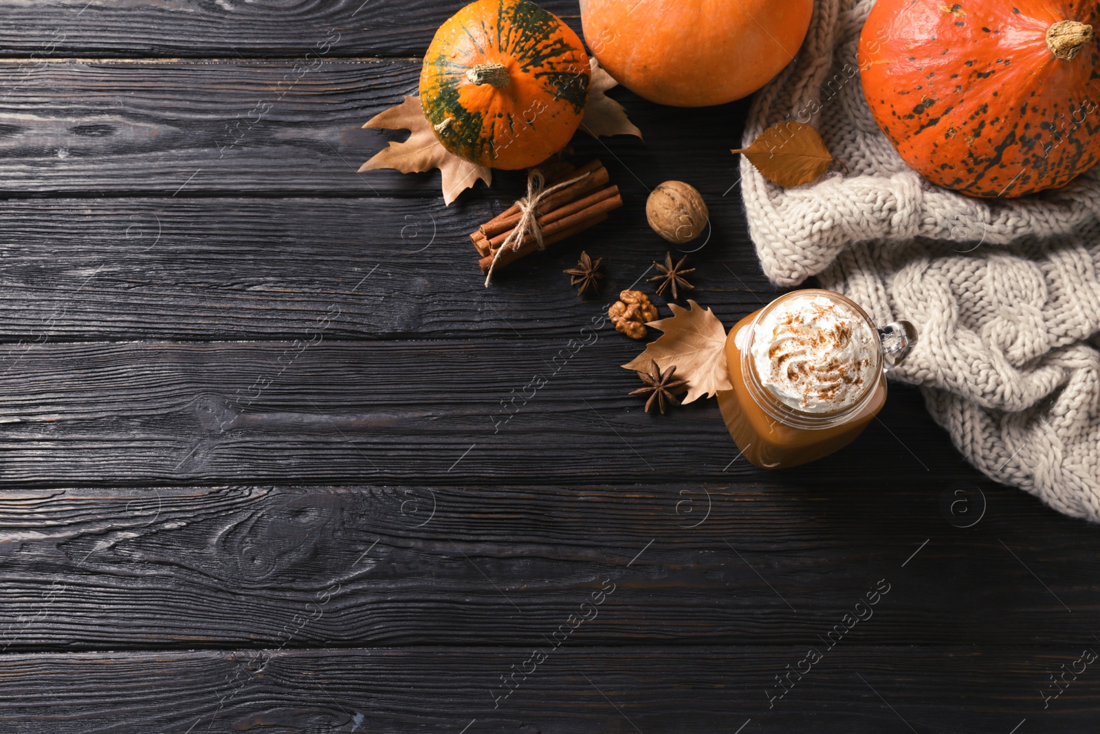 Photo of Flat lay composition with mason jar of tasty pumpkin spice latte and space for text on wooden background