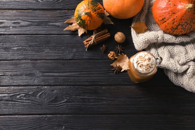 Photo of Flat lay composition with mason jar of tasty pumpkin spice latte and space for text on wooden background