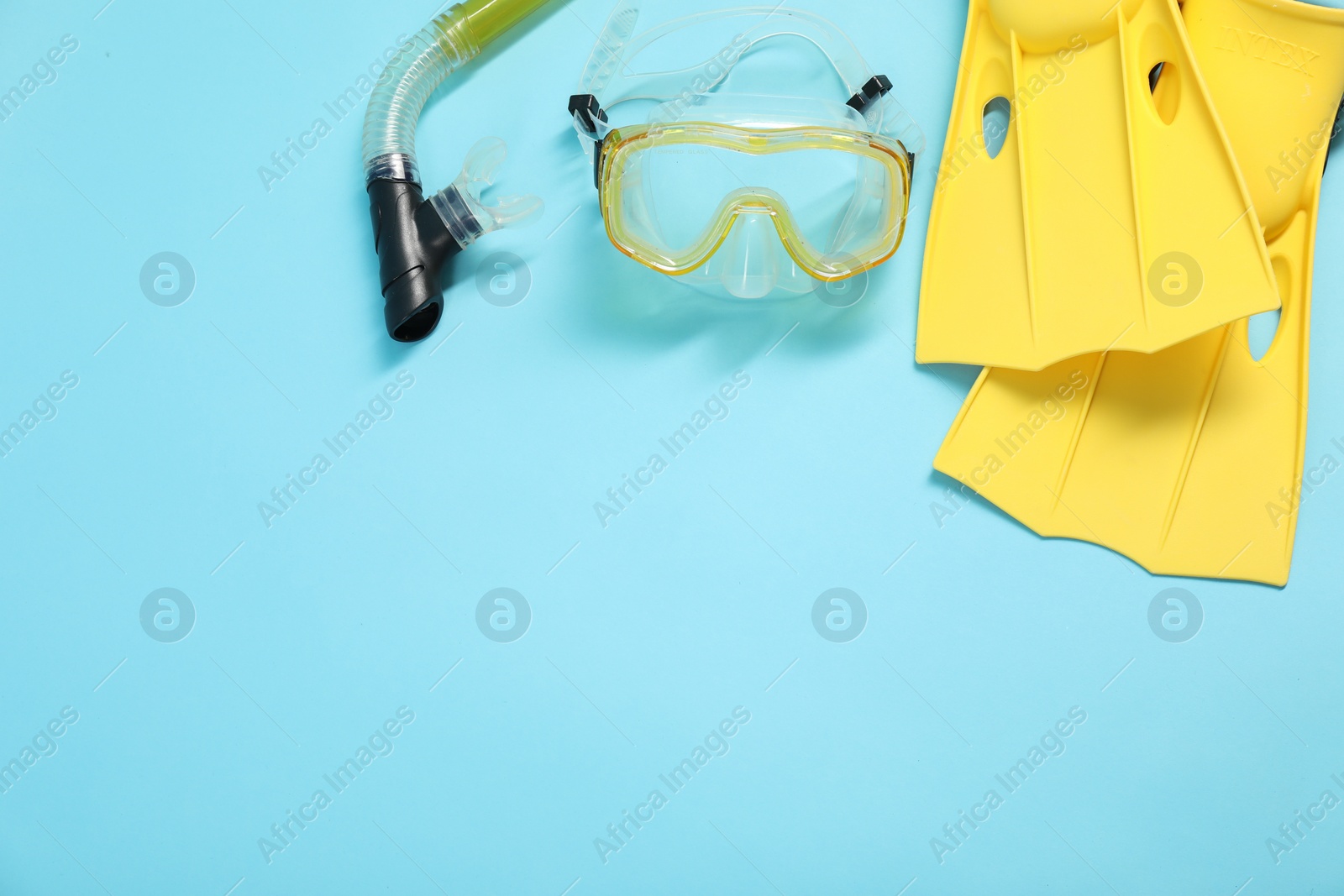 Photo of Different sports equipment on light blue background, flat lay. Space for text