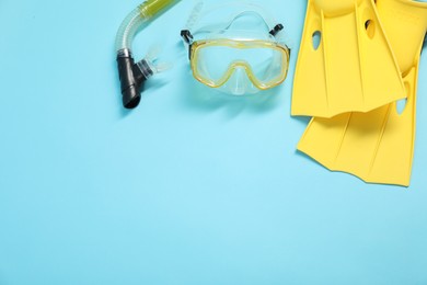 Photo of Different sports equipment on light blue background, flat lay. Space for text