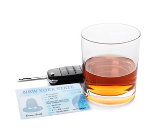 Photo of Glass of alcohol, car key and driver license on white background. Responsible driving concept