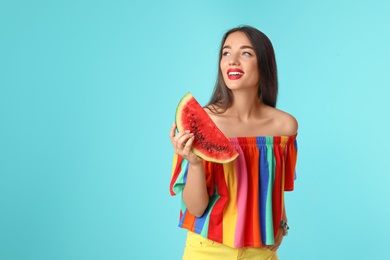 Photo of Beautiful young woman posing with watermelon on color background