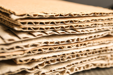 Photo of Sheets of brown corrugated cardboard as background, closeup