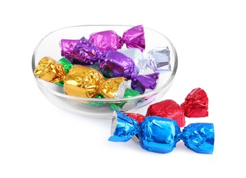 Bowl with many tasty candies in colorful wrappers isolated on white