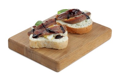 Photo of Delicious bruschettas with anchovies, eggs, basil and sauce on white background