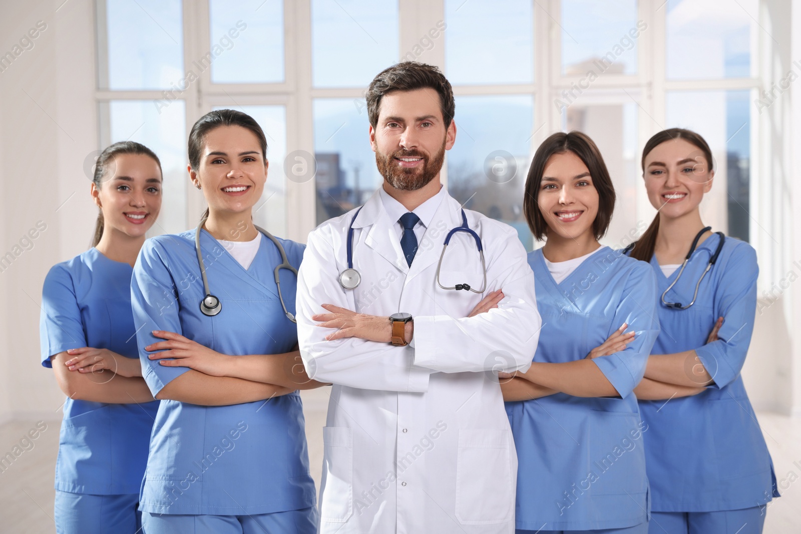 Photo of Team of professional doctors in clinic hallway