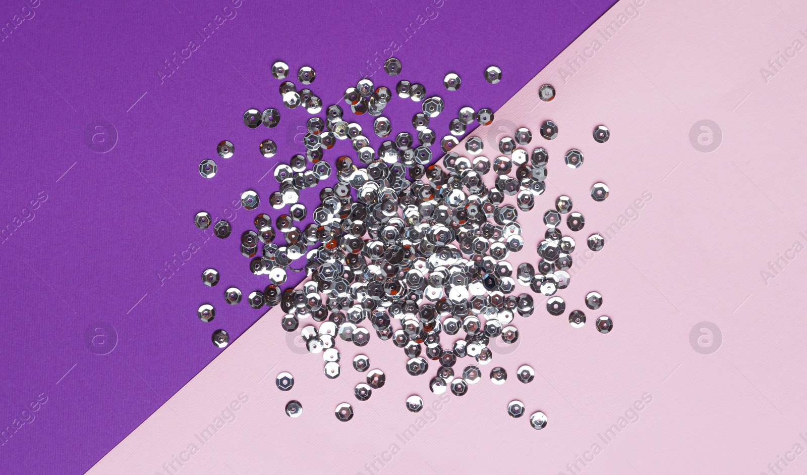 Photo of Pile of silver sequins on colorful background, flat lay