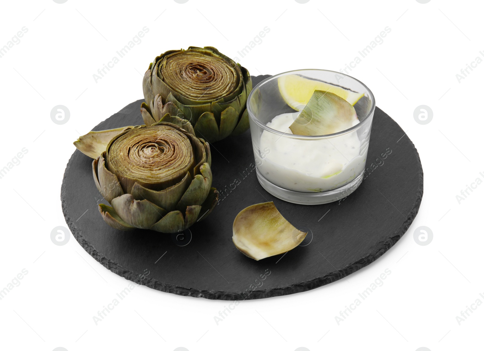 Photo of Delicious cooked artichokes with tasty sauce isolated on white