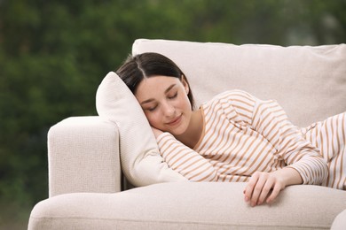 Teenage girl sleeping on sofa at home