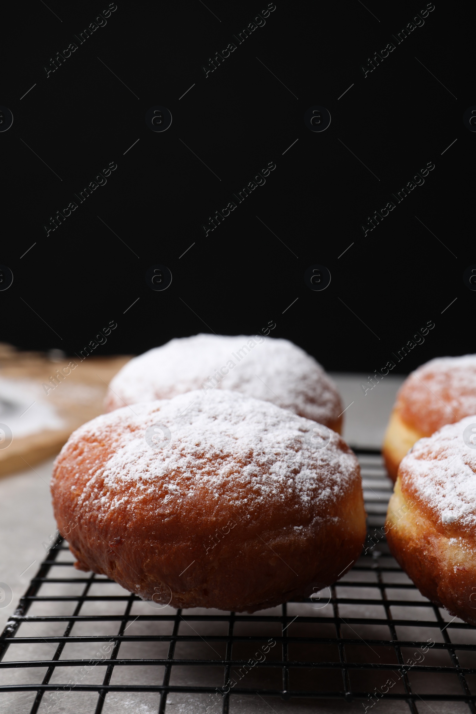 Photo of Delicious sweet buns on table against black background, space for text