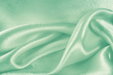 Texture of beautiful silk as background. Image toned in mint color 