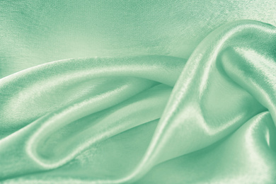 Image of Texture of beautiful silk as background. Image toned in mint color 