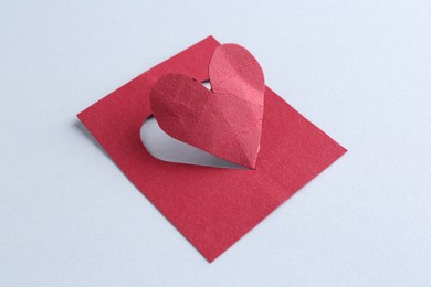 Photo of One red paper heart on gray background