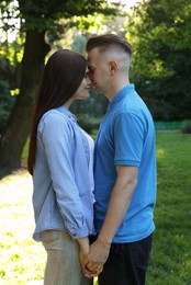 Photo of Affectionate happy young couple together in park