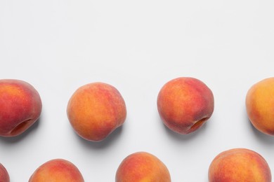 Photo of Many whole fresh ripe peaches on white background, flat lay. Space for text