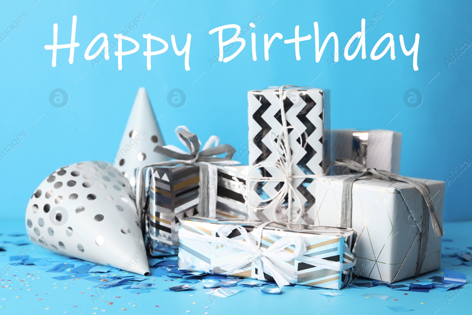 Photo of Gift boxes and text Happy Birthday on light blue background