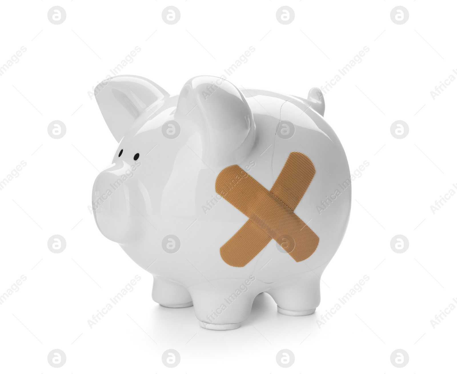 Photo of Piggy bank with sticking plasters isolated on white