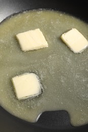 Photo of Melting butter in frying pan, closeup view