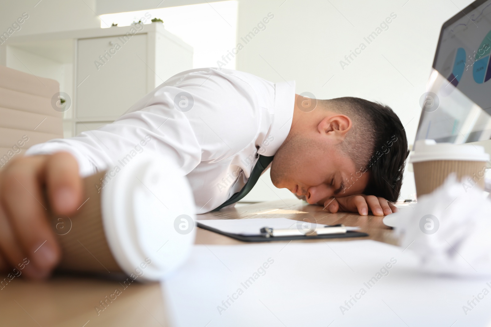 Photo of Stressed out businessman at workplace in office