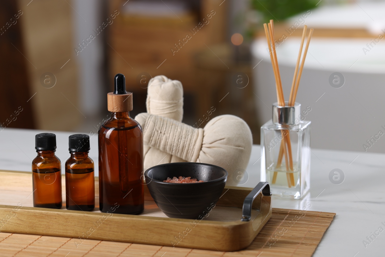 Photo of Spa products on white table in bathroom, closeup