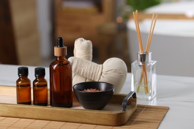 Photo of Spa products on white table in bathroom, closeup