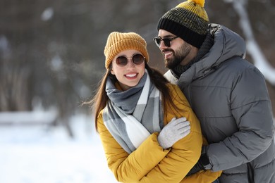 Beautiful happy couple outdoors on winter day. Space for text