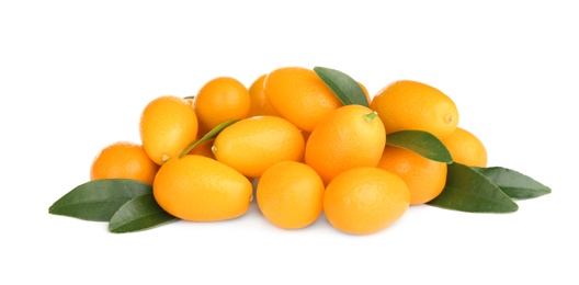 Fresh ripe kumquats with leaves on white background. Exotic fruit