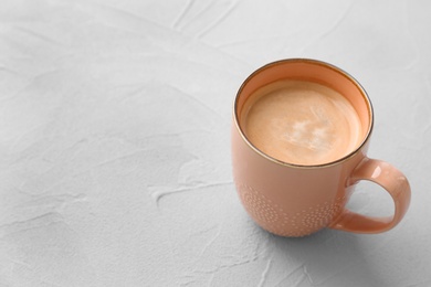 Photo of Cup of aromatic hot coffee on light background