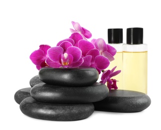 Photo of Orchid with spa stones and cosmetic on white background