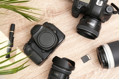 Photo of Professional photographer's equipment on wooden table, top view