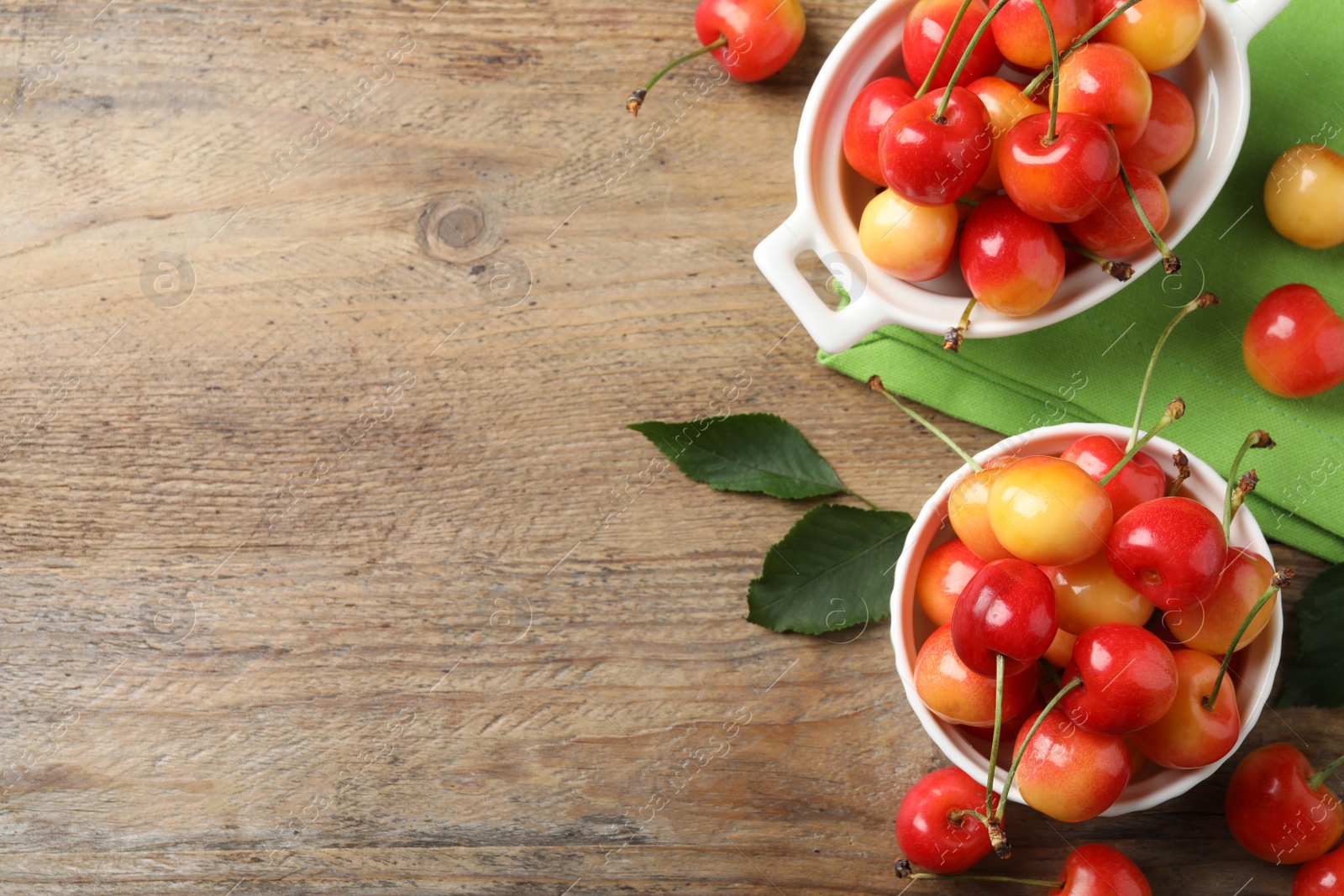 Photo of Sweet red cherries on wooden table, flat lay. Space for text