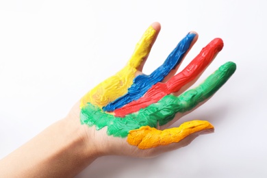 Child with painted palm on white background, closeup