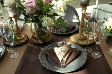 Photo of Festive table setting with beautiful tableware and floral decor indoors