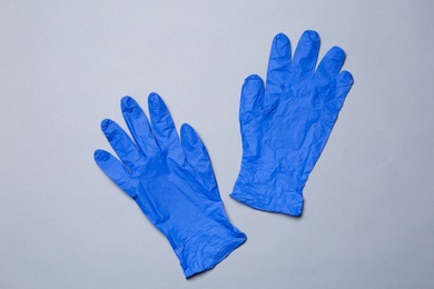 Photo of Flat lay composition with medical gloves on color background