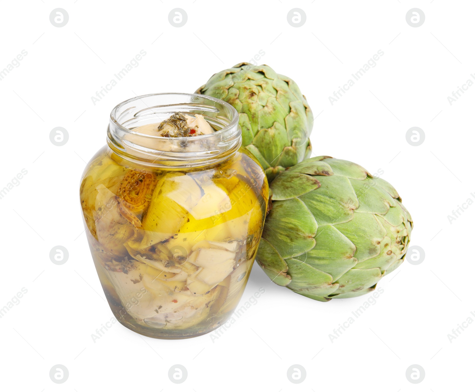 Photo of Open jar of delicious artichokes pickled in olive oil and fresh vegetables on white background