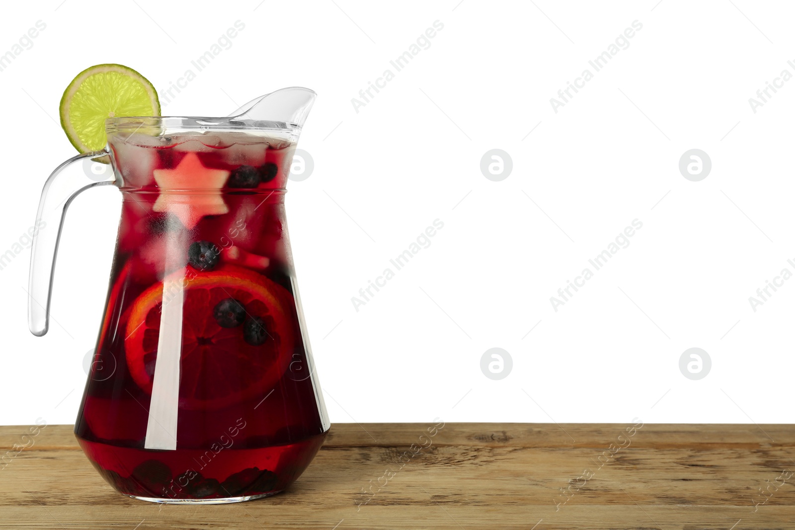 Photo of Glass jug of Red Sangria on wooden table against white background. Space for text