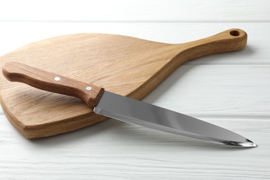 One sharp knife on white wooden table, closeup