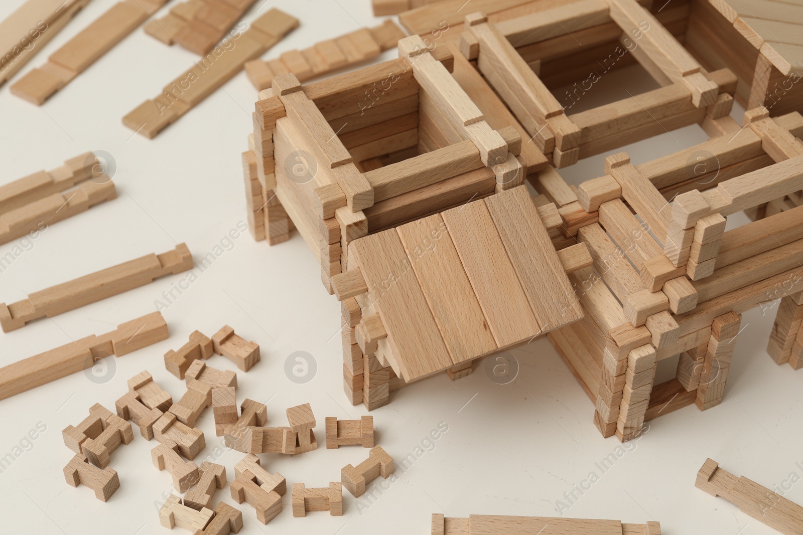 Photo of Wooden construction set on white table, closeup. Children's toy